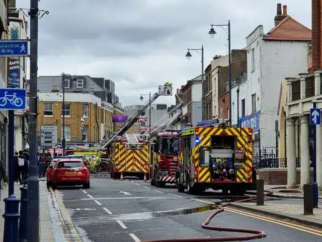 Kent Fire and Rescue Service remains at the scene of a fire at a commercial premises at the junction of Queen Street and Milton Road, in Gravesend
