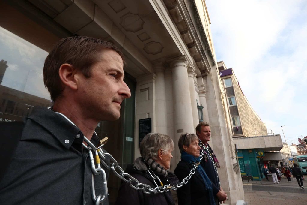 Extinction Rebellion Protesters Arrested After Chaining Necks To Brighton Barclays