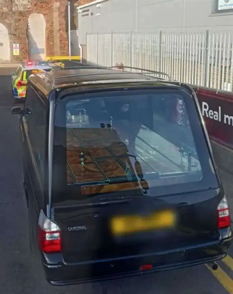 A hearse driver has been caught using his mobile while driving
