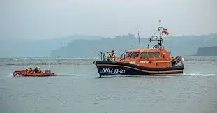 Exmouth RNLI Lifeboat Team Heroically Rescues Wing Boarder and Fallen Climber in Same Day