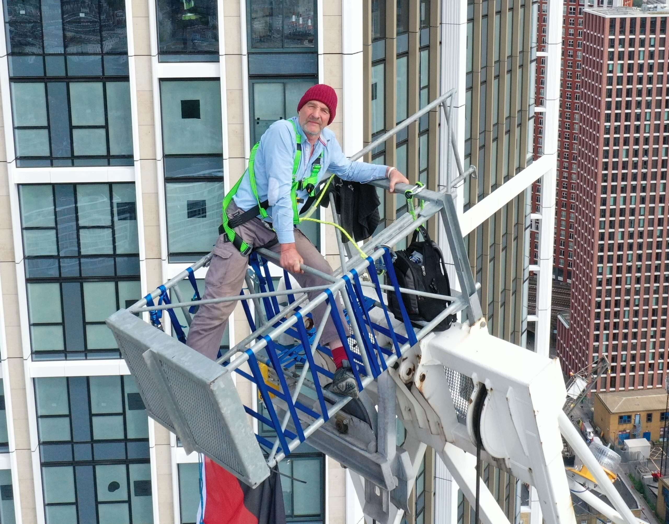 Updated:a 69-year-old Protester Has Mounted A Crane At A Nine Elms Building Site And Unfurled A Palestinian Flag As Police Try To Talk Him Down