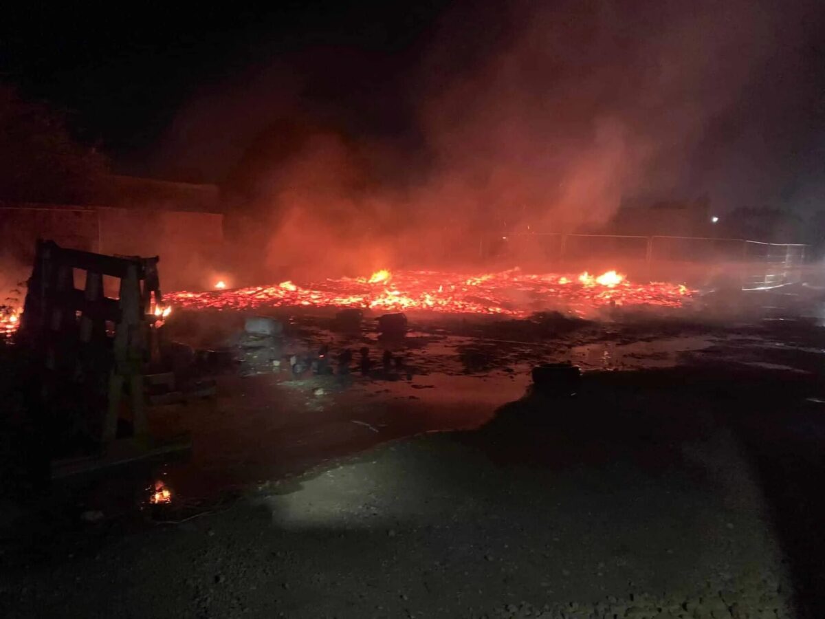 Fire crews tackle large blaze involving a large number of pallets and gas cylinders