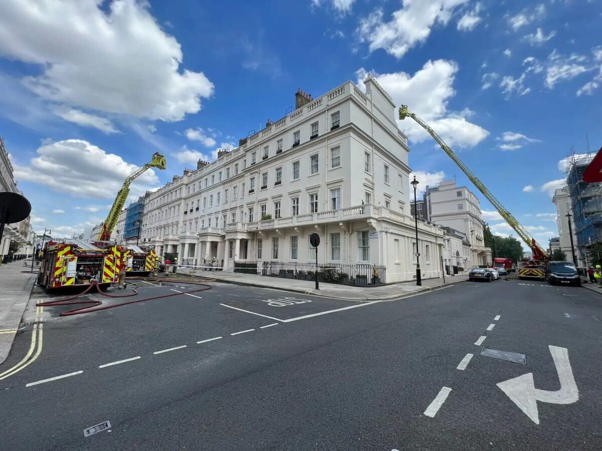 Firefighters responded to a fire at a five-story residential townhouse, where the fire destroyed the roof, a third-floor flat, and a fourth-floor flat