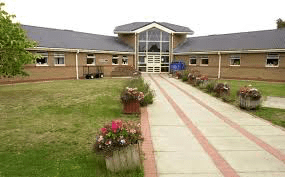 Two people have been arrested after a suspicious package containing suspected drugs and mobile phones was thrown into Erlestoke prison gr…