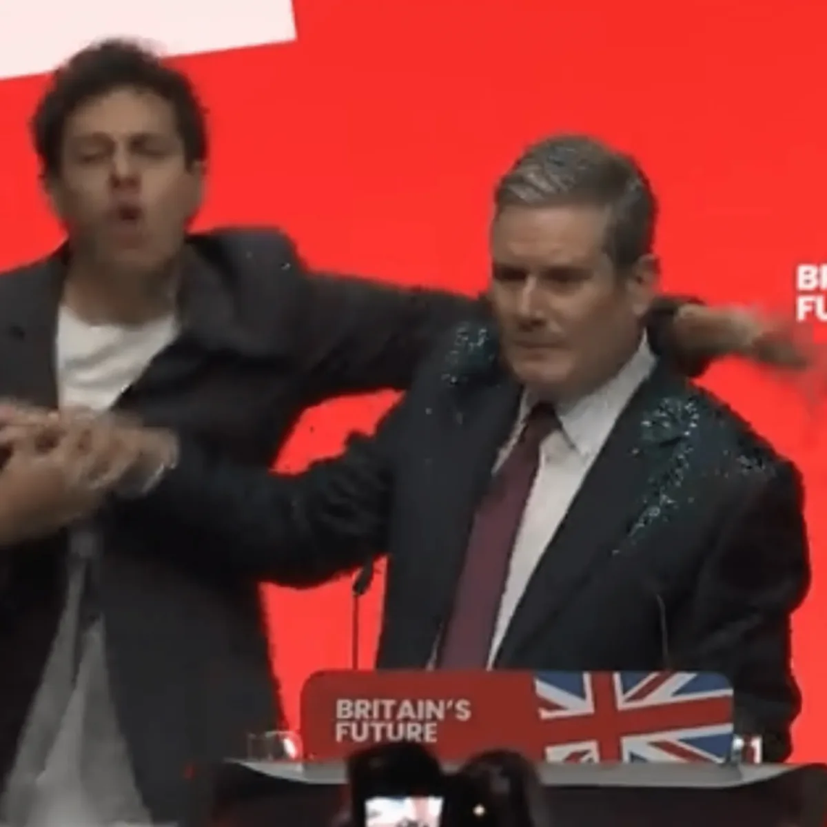 Protester Storms Stage and Covers Sir Keir Starmer in Glitter at Labour Conference