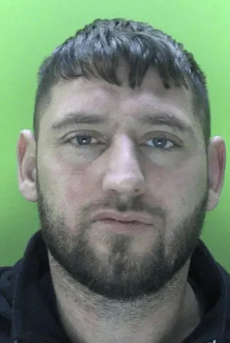 A violent drug dealer has been jailed after police found bags full of cocaine in his kitchen