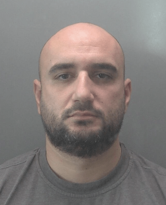 A drug dealer with an axe in the car, four boxes and bags full of cannabis and nearly £1,000 in cash was caught by officers