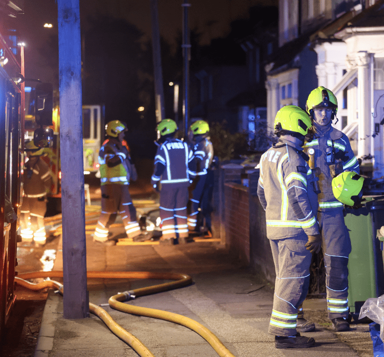 Firefighters at night-time emergency incident.