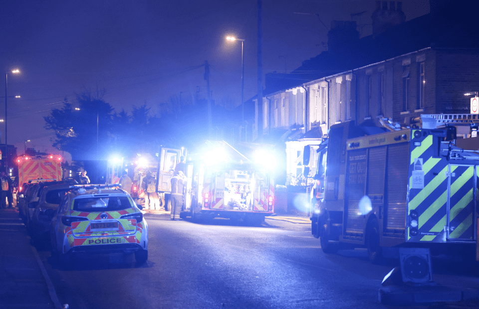 Emergency services at nighttime incident on UK street.