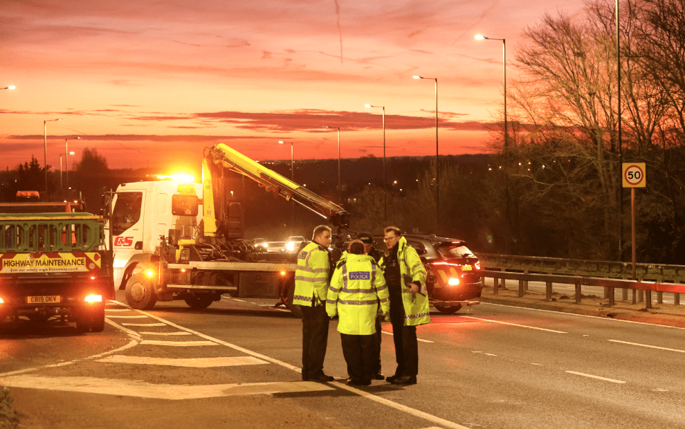 Highway police and maintenance at dusk.