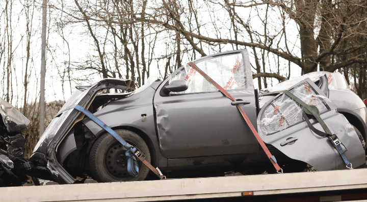 Wrecked car on tow truck after accident.