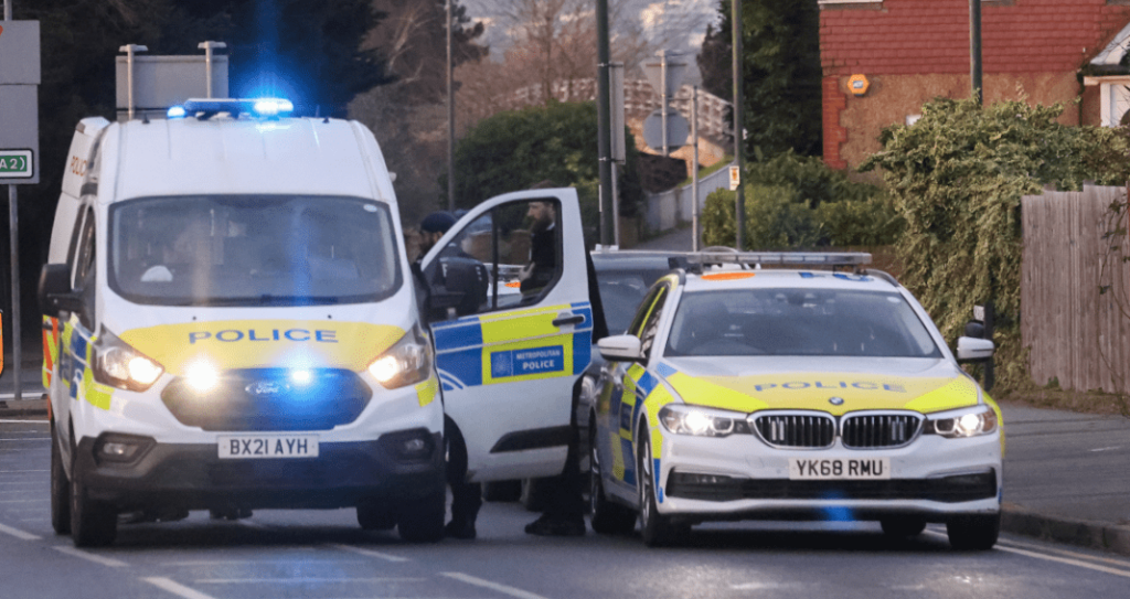 UK police vehicles responding with flashing lights.
