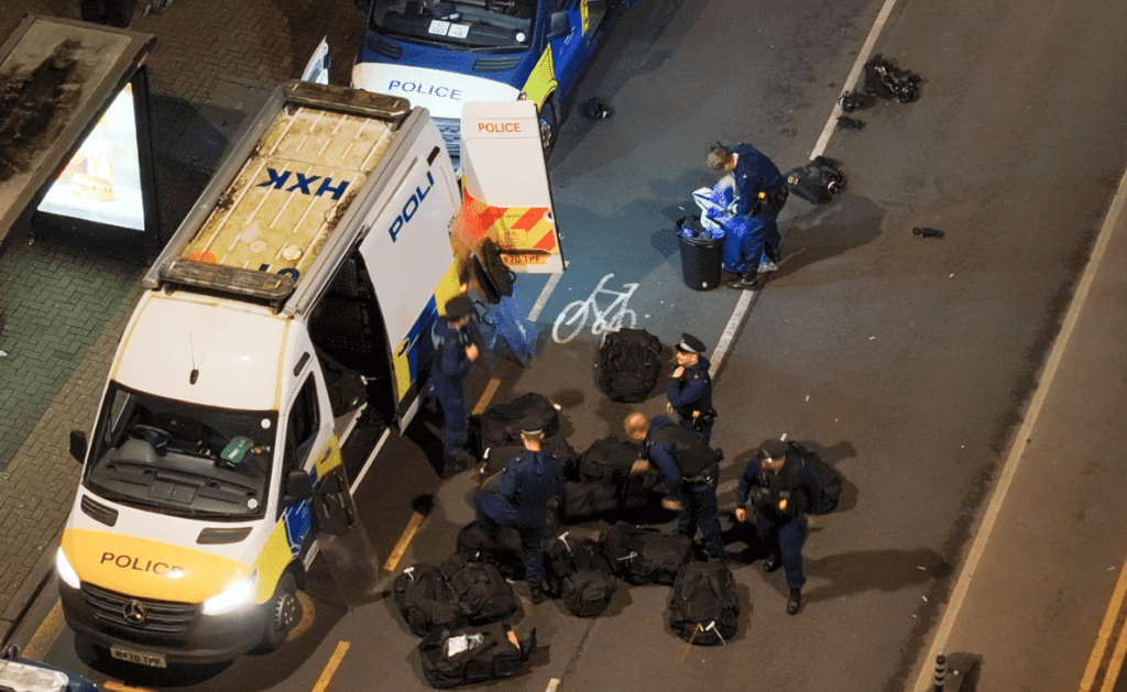 Overhead view of police at nighttime operation.