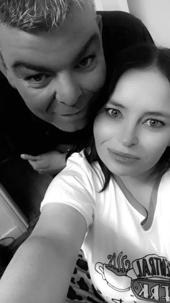Two people posing for a black and white selfie.
