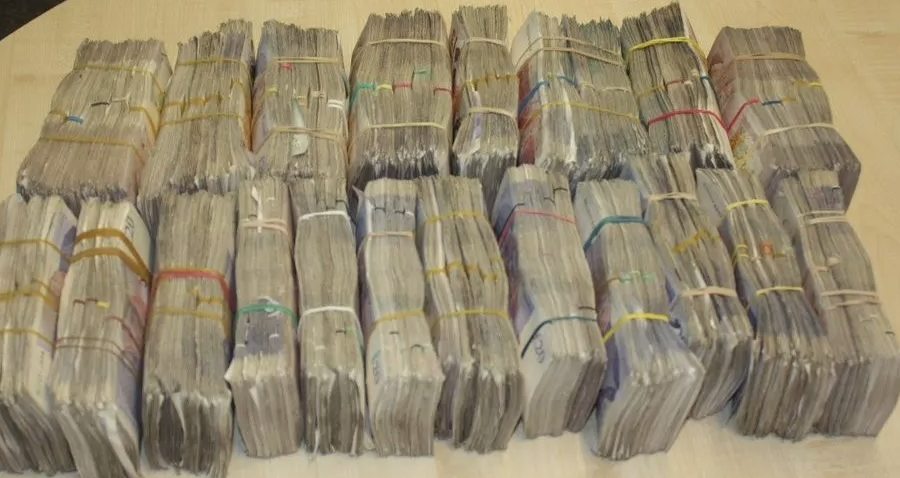 Three people have been charged after £200,000 in cash was recovered from a vehicle at the Channel Tunnel