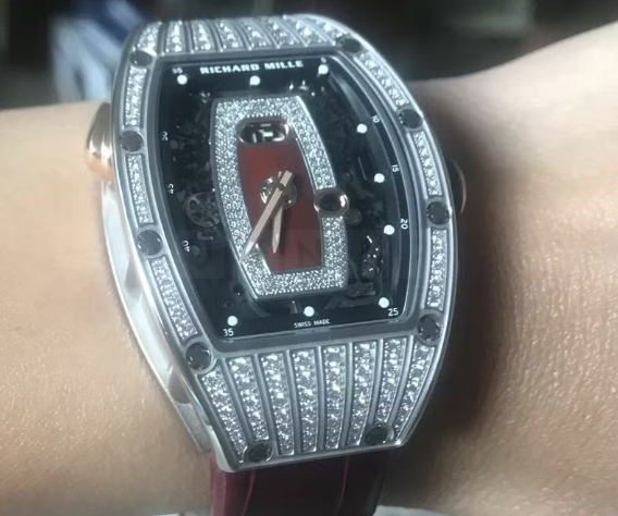 Detectives are appealing for information after a woman had her designer watch stolen in a violent robbery in front of her children