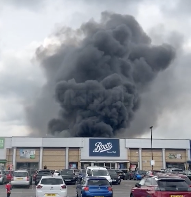 Fire Erupts Behind Retail Park, Sending Thick Smoke Across Manchester