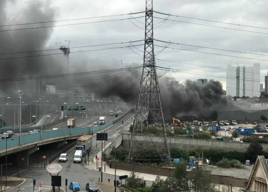 Huge Blaze Engulfs Canning Town Glass Factory – 60 Firefighters Battle Fierce Fire