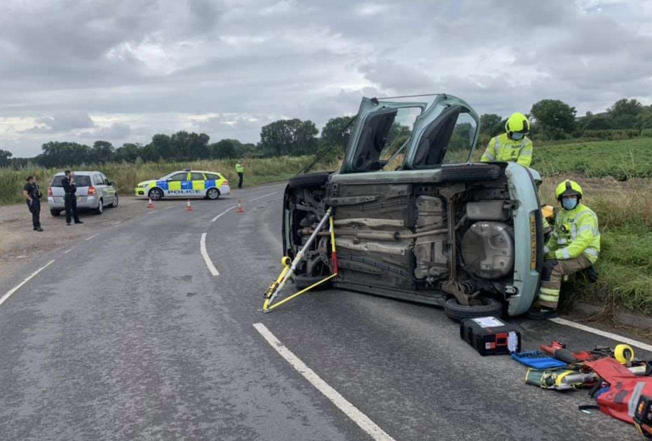 Fire crew cut woman from vehicle using hydraulic cutting equipment