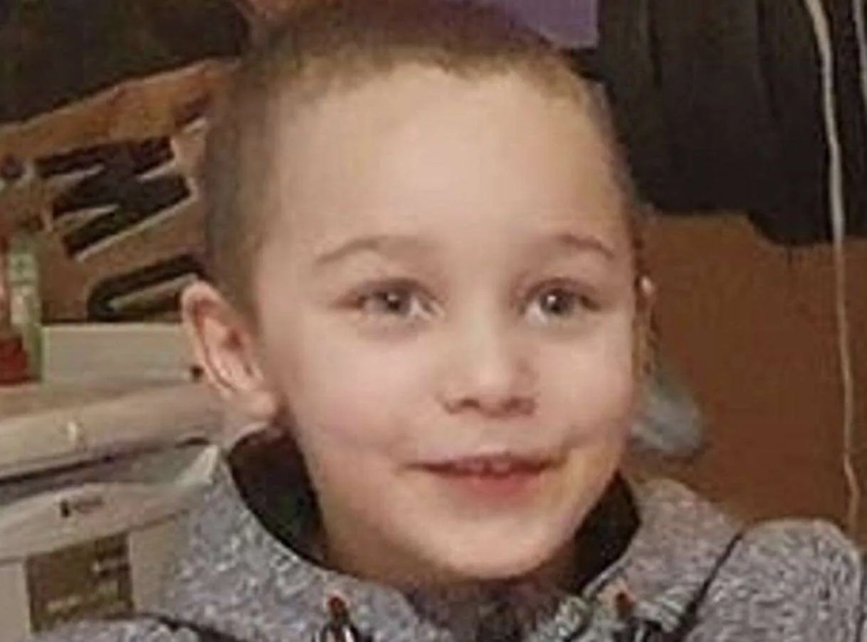 Two adults and a teenager have appeared in court after the body of a five-year-old boy was found in a river