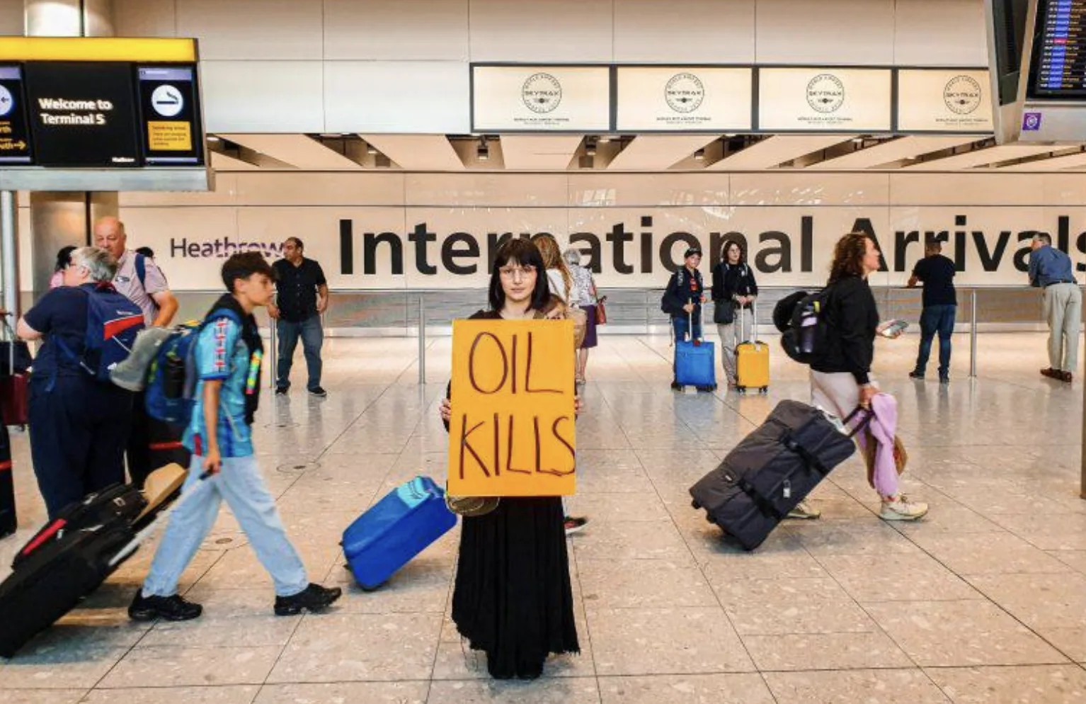 Just Stop Oil Activist Dragged from Heathrow Terminal Five Over “Oil Kills” Protest in Global Climate Campaign