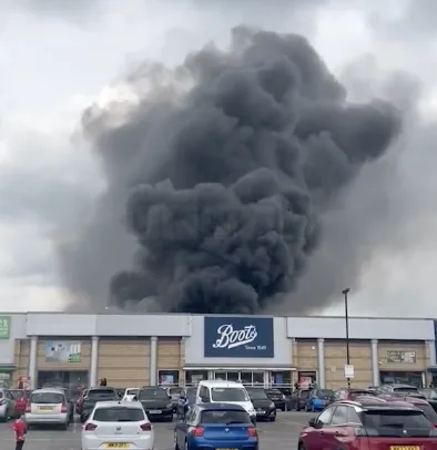 Massive Scrap Yard Blaze Behind Altrincham Retail Park Sends Thick Smoke Over Manchester