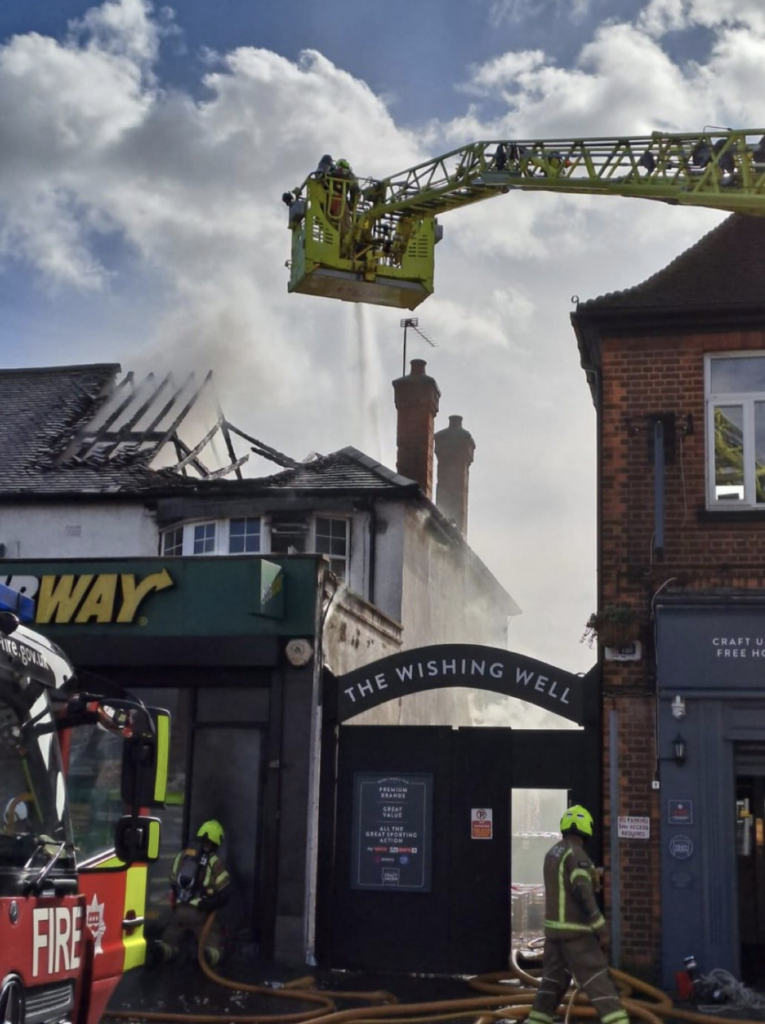 Massive Blaze Destroys Chingford Flats and Shop – Woman and Child Hospitalised as Fire Brigade Launches Investigation