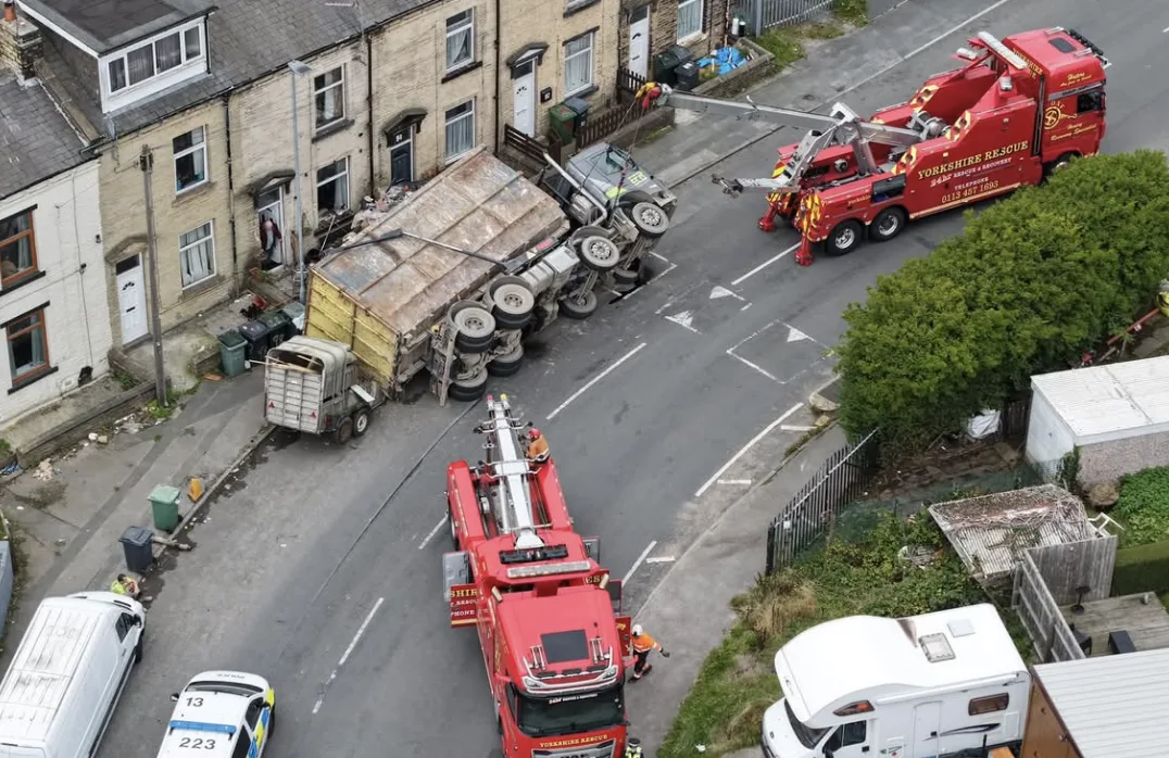 HGV misses Bradford house by inches after crushing car and horse box