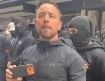Danny Tommo leads masked protest outside Daily Mail HQ in London