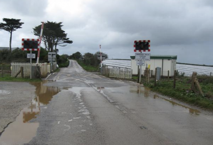 Train hits debris after car crashes into Cornwall level crossing