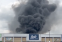 Fire Erupts Behind Retail Park, Sending Thick Smoke Across Manchester